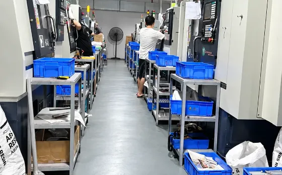 Operators loading parts between CNC lathes in the Dongguan plant